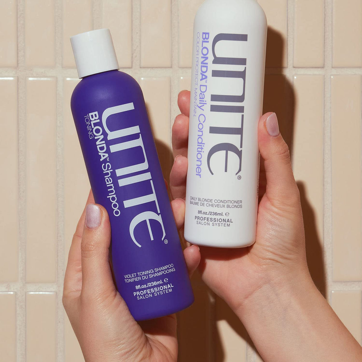 UNITE Hair 8 fl oz bottle held next to hand for size and scale