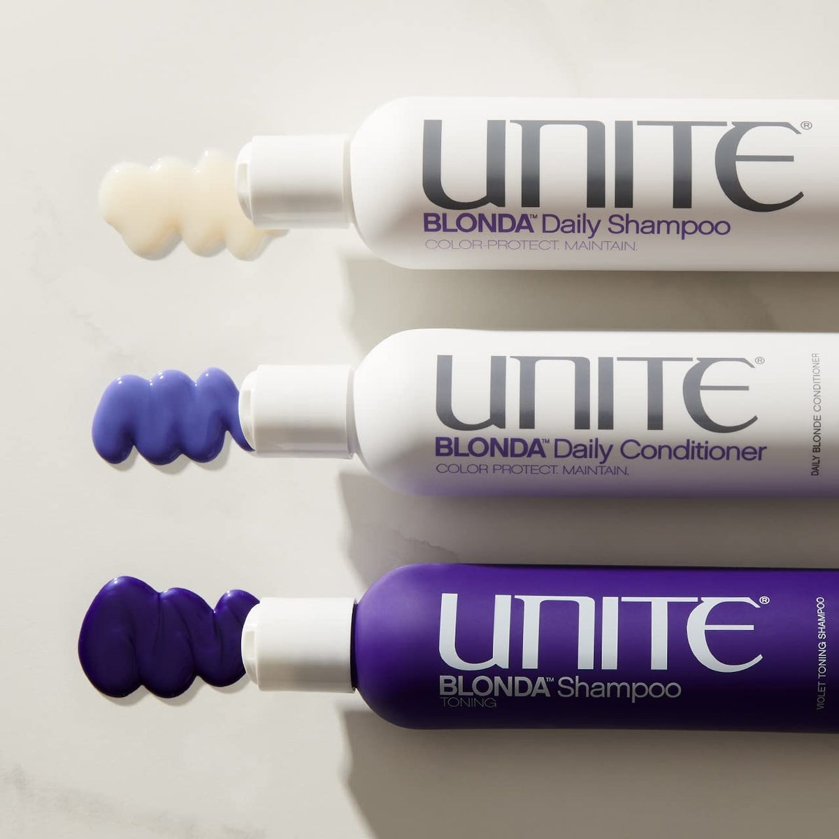 UNITE BLONDA 8oz bottle beside hand for size comparison and travel convenience