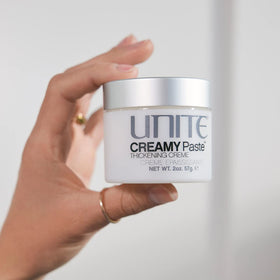UNITE CREAMY Paste used on finished hairstyle in a salon setting, adds thickness and piecey separation