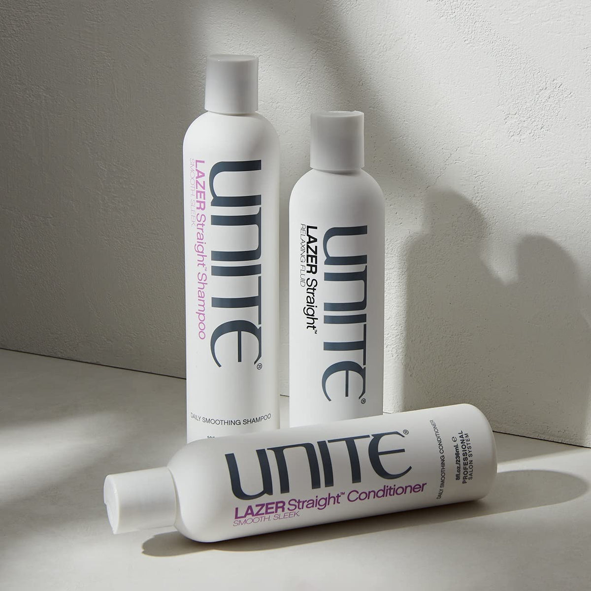 UNITE LAZER Straight Shampoo next to measuring cup showing 10 fl oz size