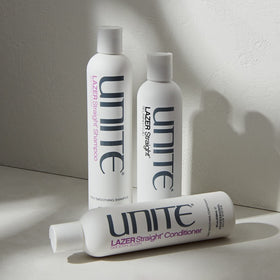 UNITE LAZER Straight Shampoo next to measuring cup showing 10 fl oz size