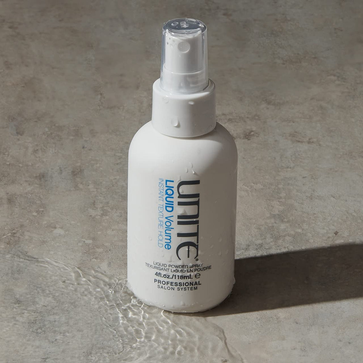 UNITE LIQUID Volume spray mist close-up highlighting quick-dry texture and matte finish