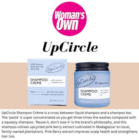 UpCircle jar beside coconut and grapefruit showing size comparison and natural ingredient focus