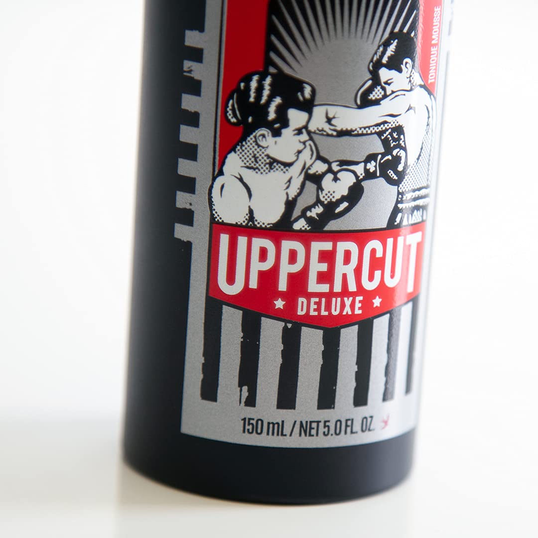 UPPERCUT DELUXE bottle held in hand showing scale and travel-friendly size benefit