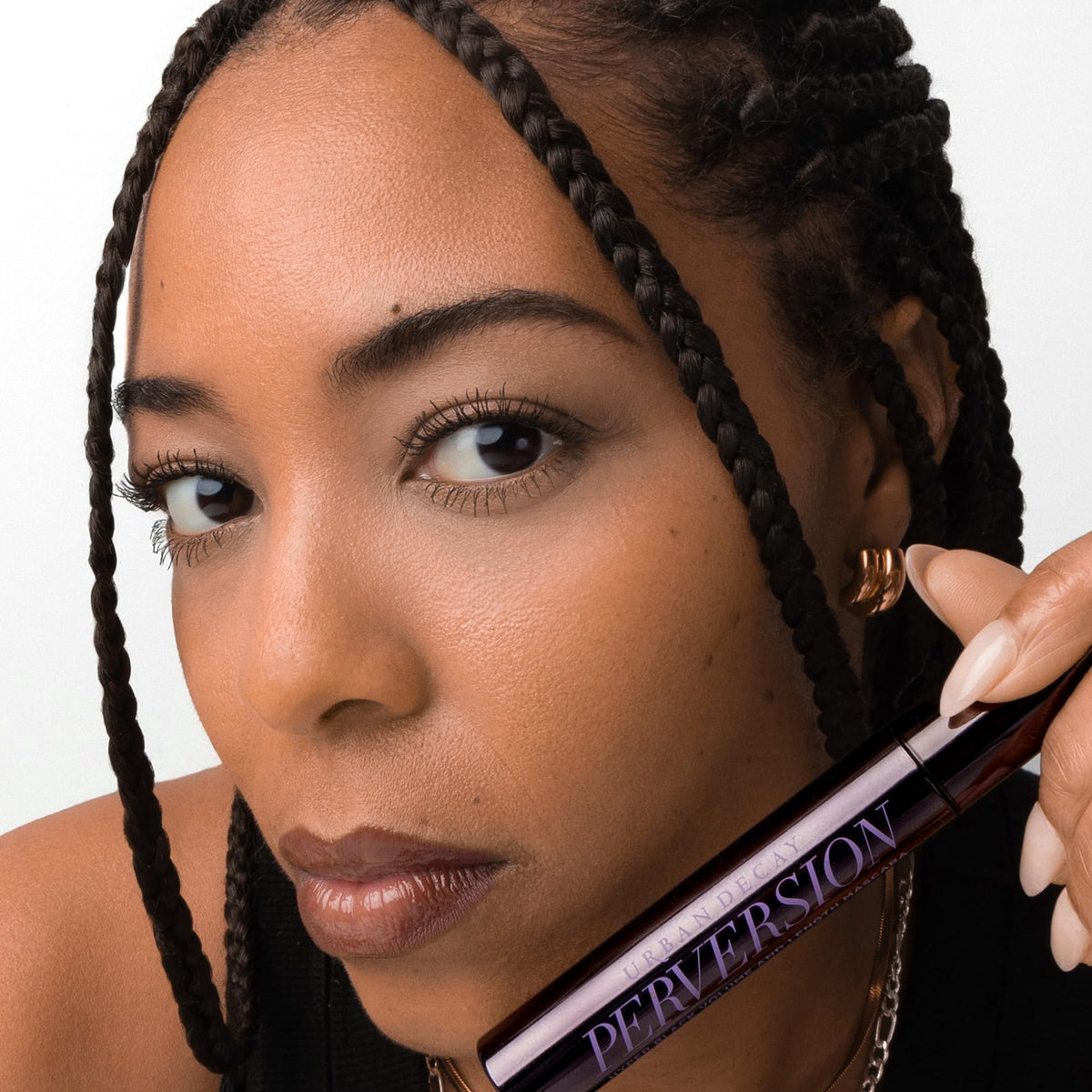 Urban Decay size comparison next to ruler illustrating compact travel-friendly 0.34 fl oz tube