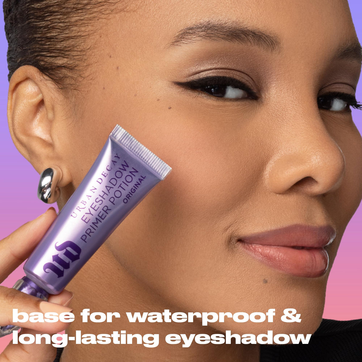 Urban Decay primer surrounded by eyeshadows demonstrating intensified pigment payoff benefit