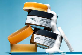 Urban Skin Rx cleansing bar in shower scene conveying daily routine oil-control benefit