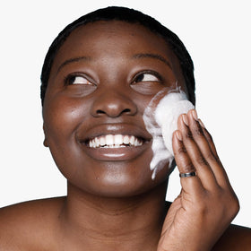 Urban Skin Rx bar beside enclosed sponge illustrating easy lathering and application benefit