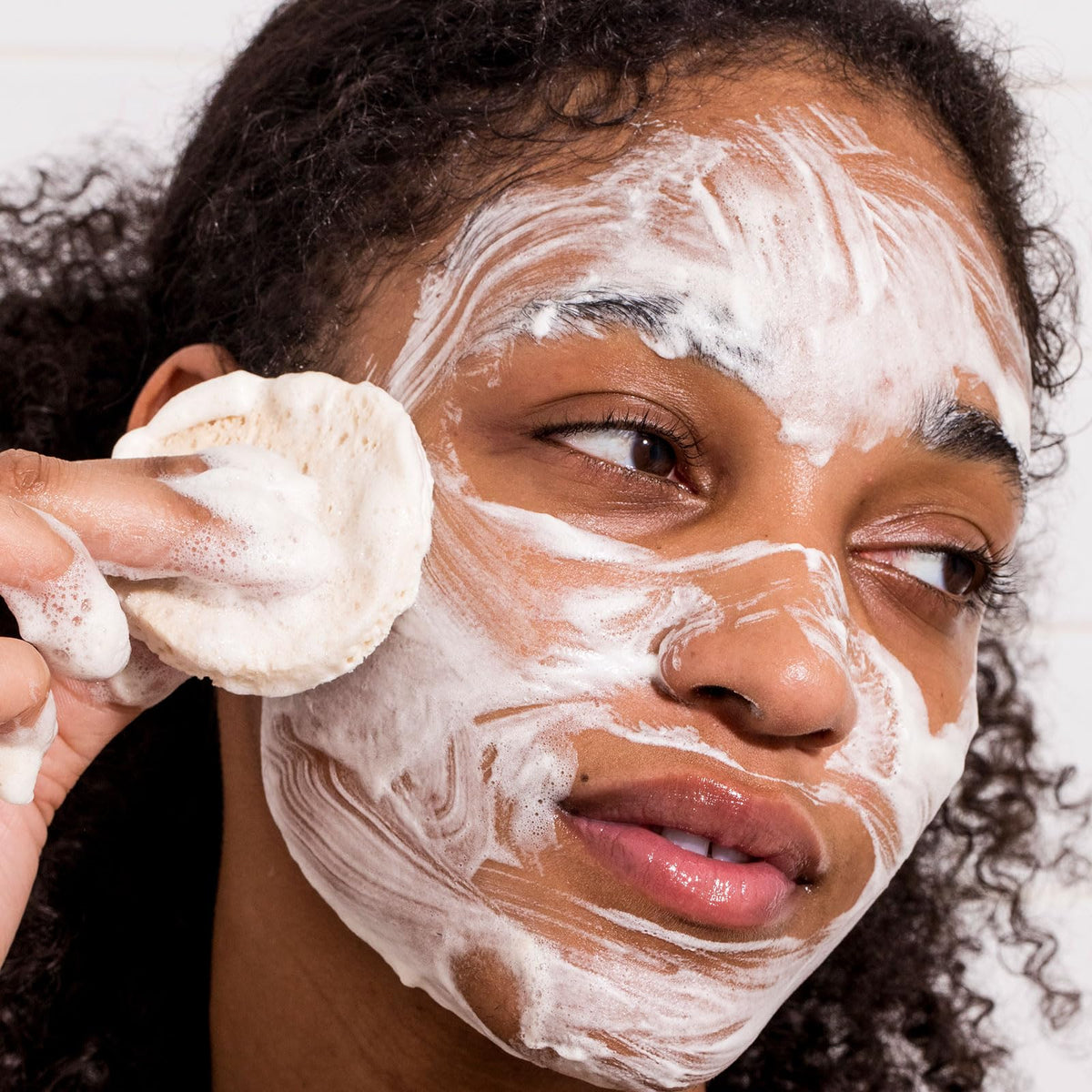 Urban Skin Rx foamy lather on face demonstrating clarifying action