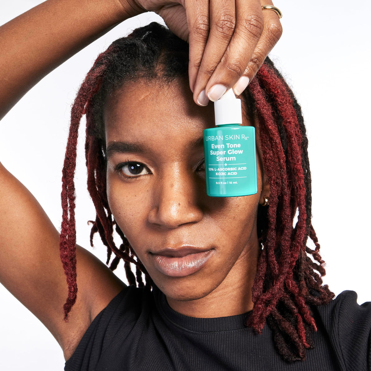 Urban Skin Rx serum next to sunscreen illustrating daytime protection benefit