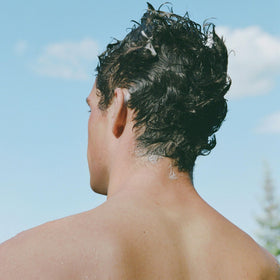 Product label and ingredients list on Ursa Major bottle showing transparency