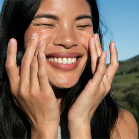 Ursa Major serum in hand illustrating easy spread and hydration benefit