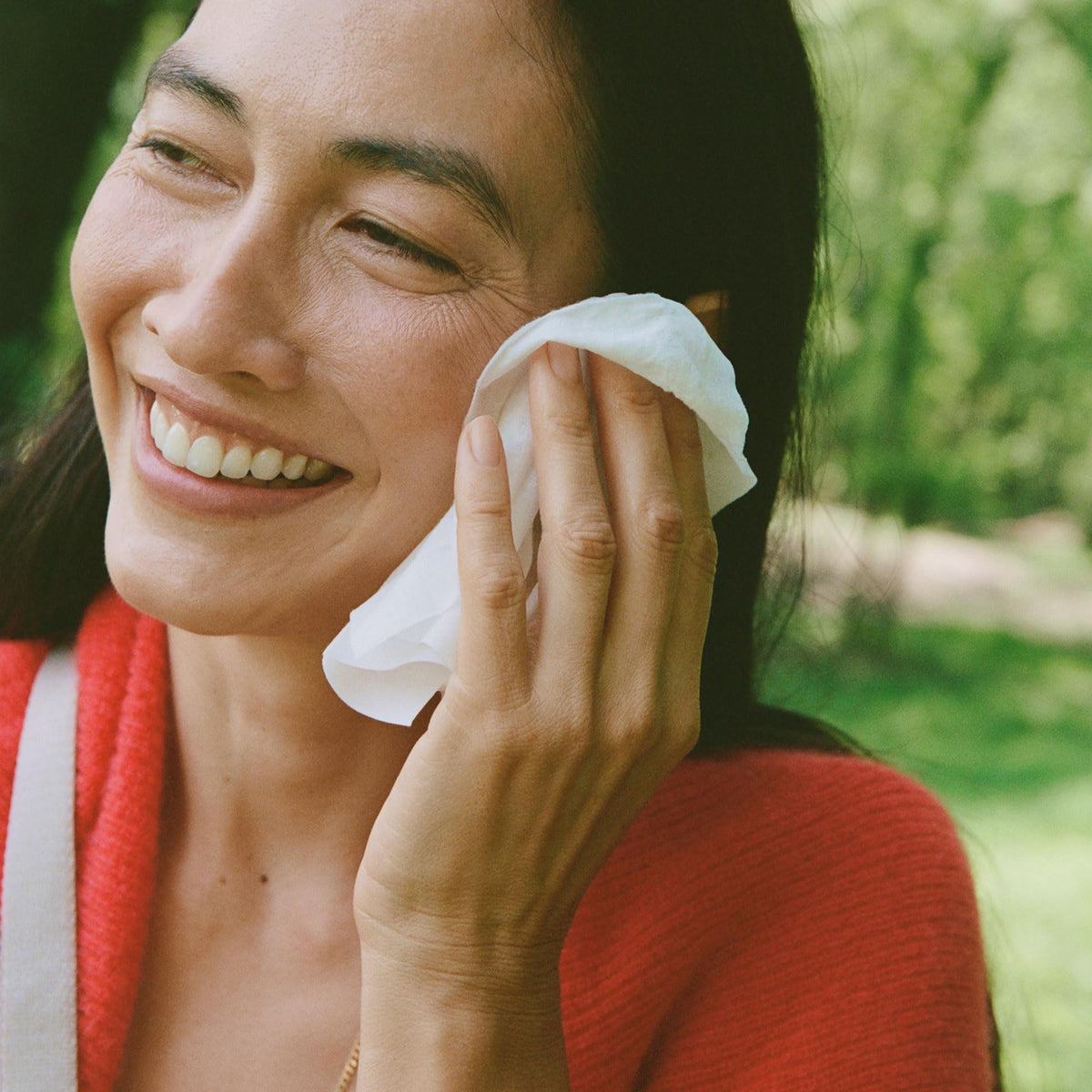Ursa Major wipe in hand removing makeup for quick post-workout refresh