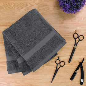 Utopia Towels size comparison with hand to show 16x27 inch useful scale