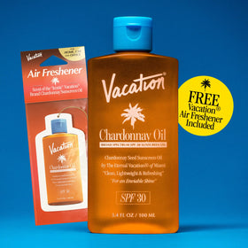 VACATION bottle on a beach towel illustrating outdoor protection and glow