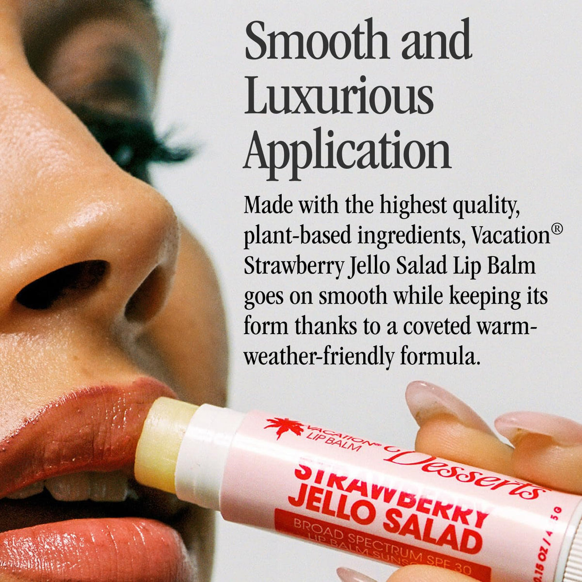 VACATION lip balm held next to a hand to show compact travel-friendly size and convenience