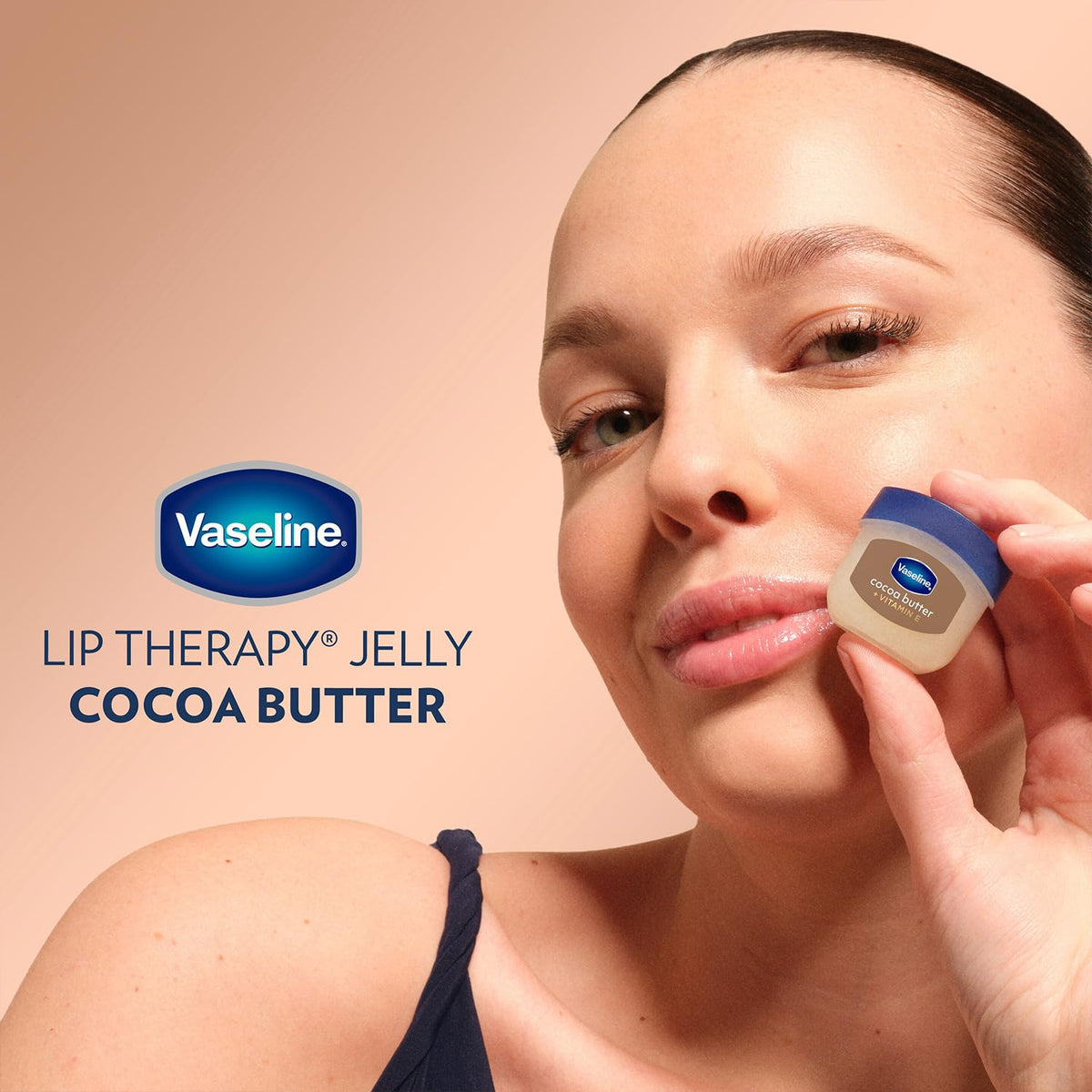 Applying Vaseline cocoa butter onto lips for instant softening and protection