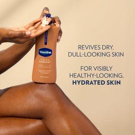 Vaseline bottle next to hand for size comparison and travel practicality