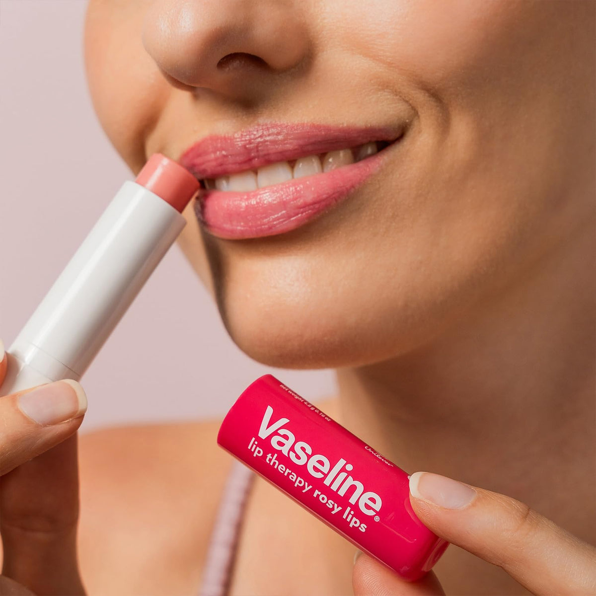 person applying Vaseline balm outdoors illustrating weather protection and quick hydration