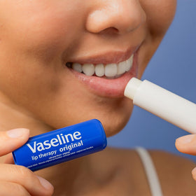 Vaseline stick in purse illustrating travel-ready protection on the go