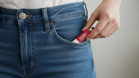 Vaseline Lip Rosy in a purse pocket illustrating on-the-go protection and tint