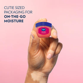 Hand holding Vaseline Rosy Lips jar to show size and portability benefit