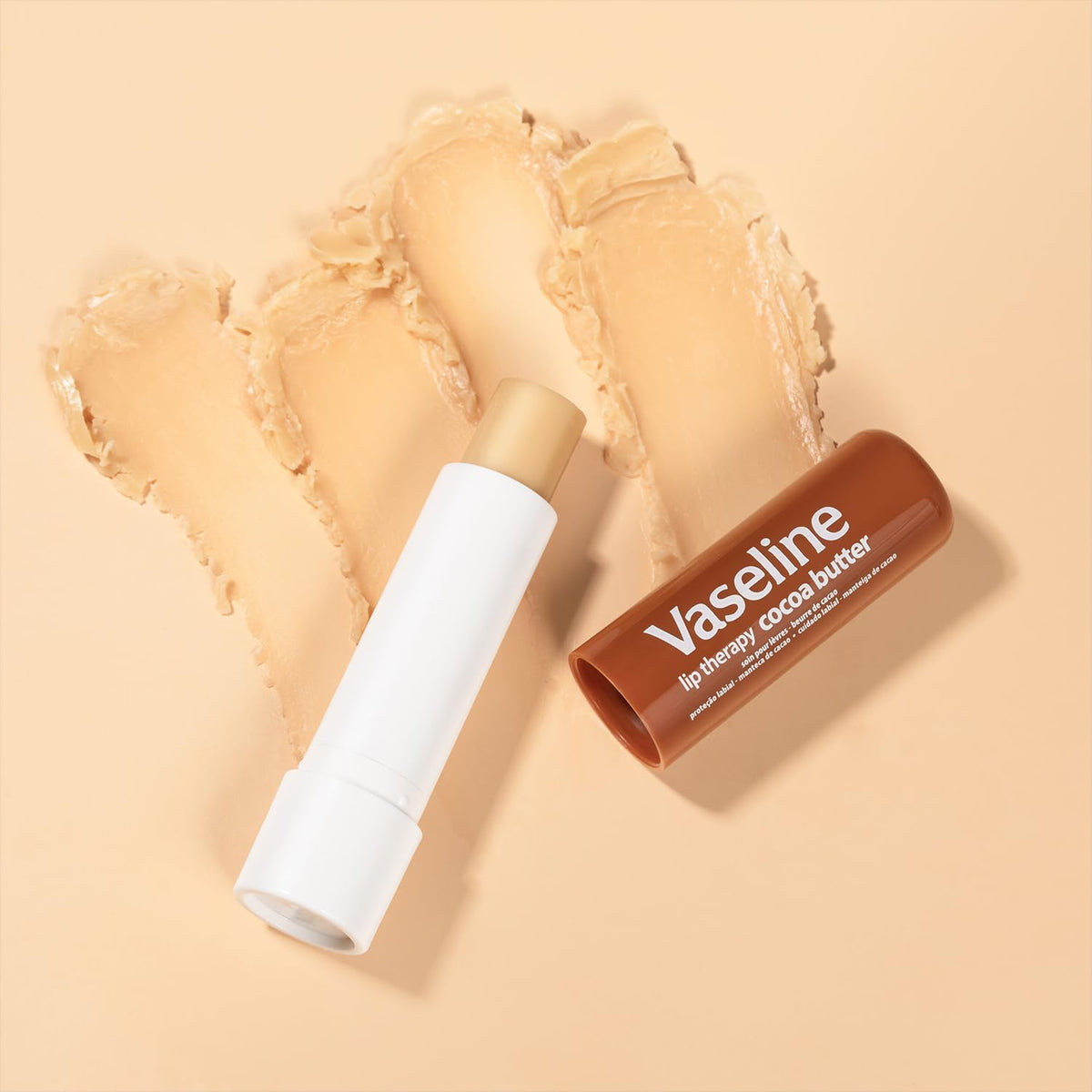 Hand holding Vaseline bottle and lip stick for scale showing travel-friendly sizes