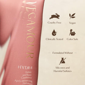 VEGAMOUR conditioner bottle next to hand to show true product size