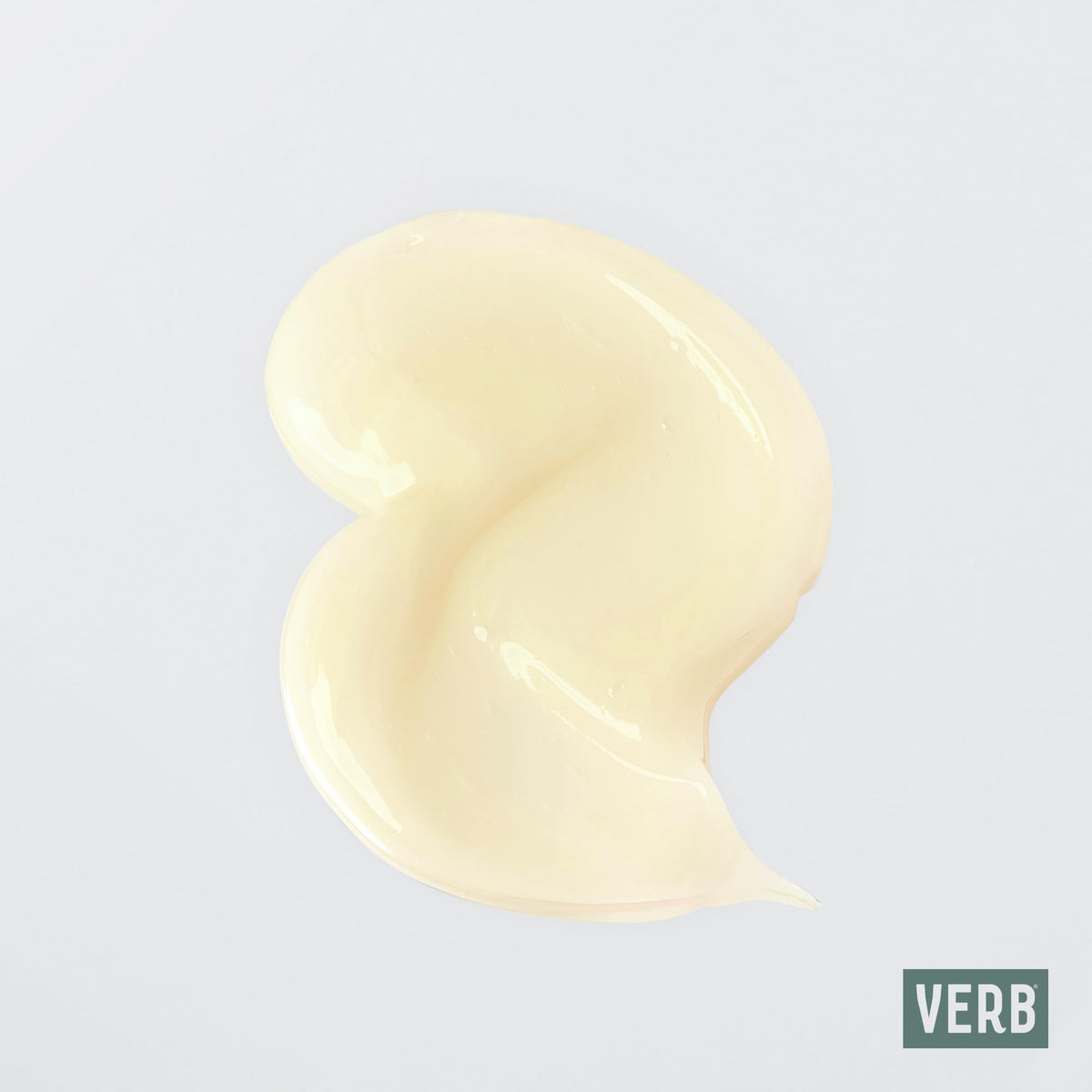 VERB curl cream being applied to damp curls demonstrating defined, softer hair