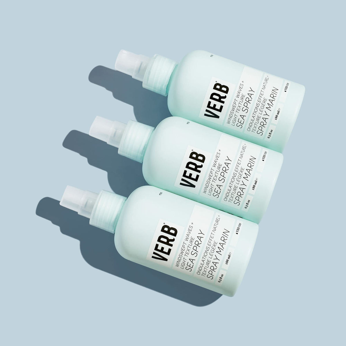 VERB bottle in hand to show size and portability for on-the-go styling