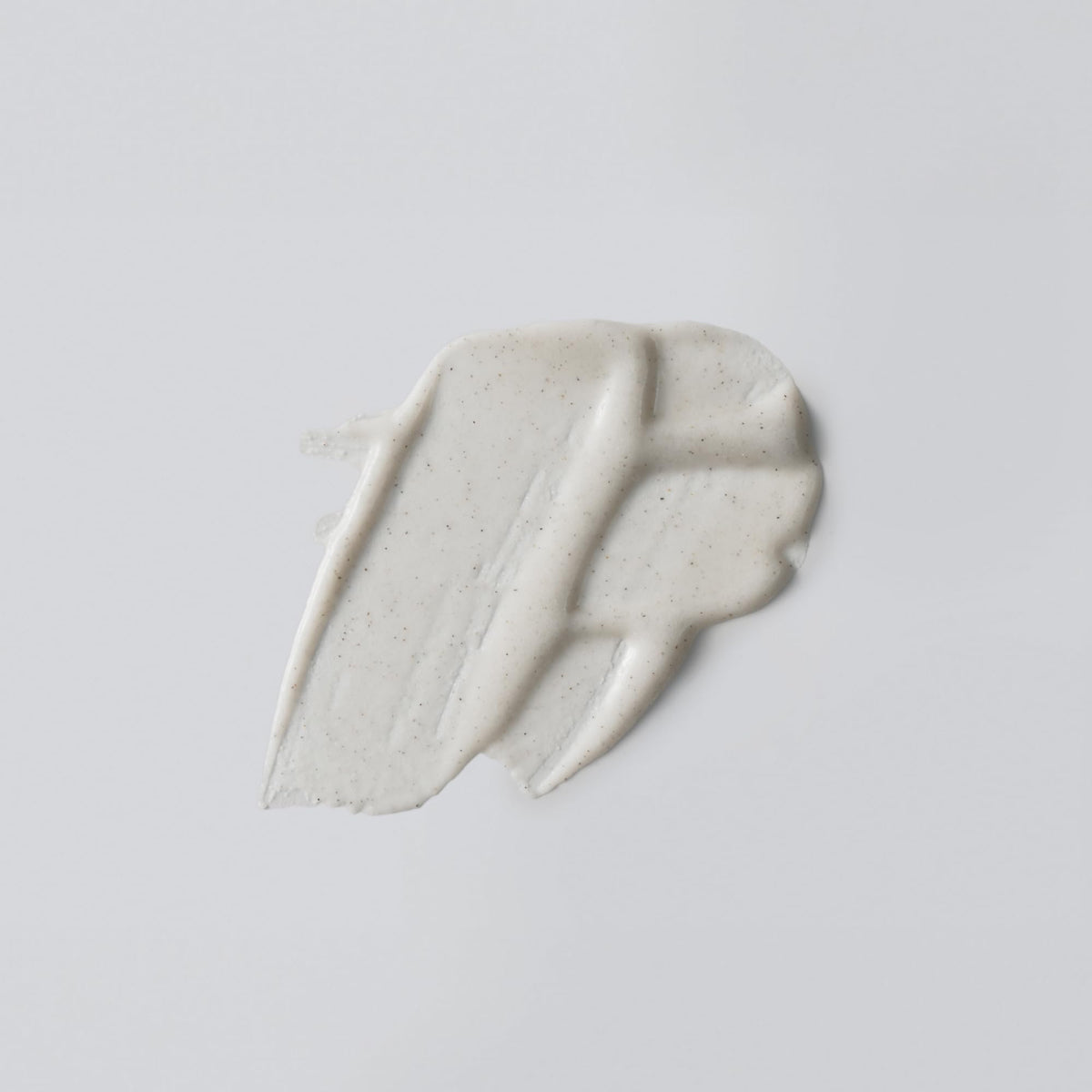 Versed creamy scrub texture close-up showing exfoliating balance