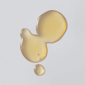 Versed Weekend Glow serum texture on fingertip close-up illustrating lightweight hydration and glow