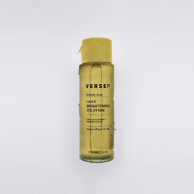 Versed Weekend Glow in hand scale comparing 4 fl oz bottle for travel-friendly size