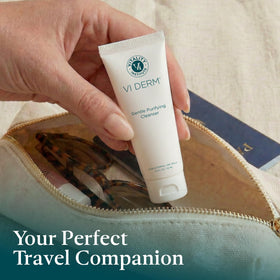 VI DERM bottle beside toiletry items showing TSA-friendly size and packability