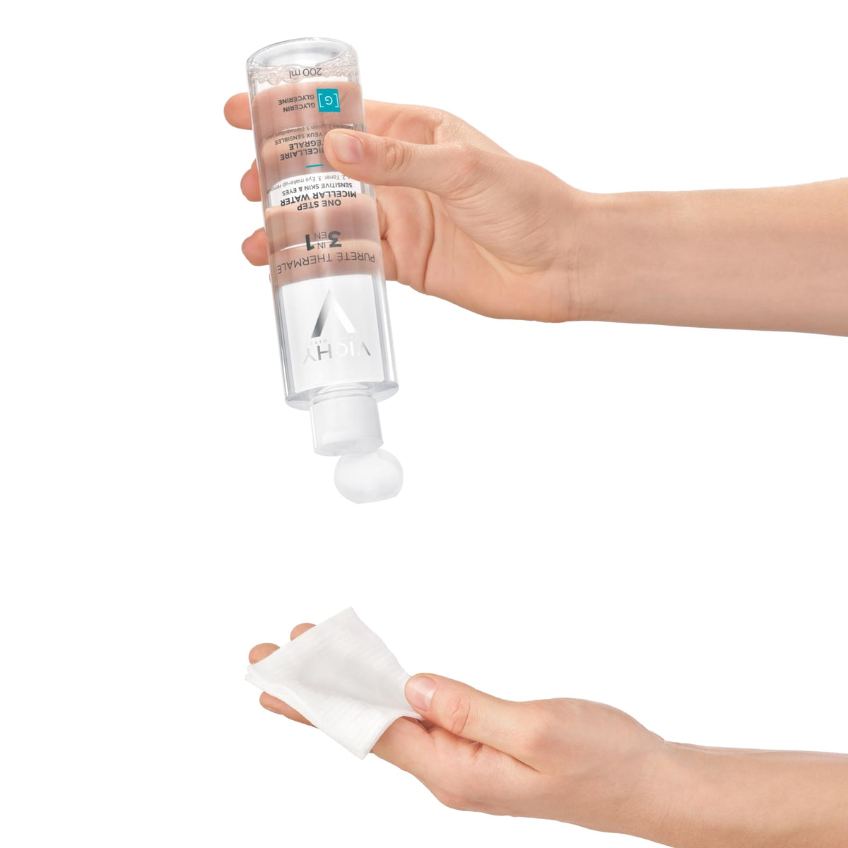 Vichy bottle held next to a hand to show product size and scale