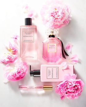 Victoria's Secret bottle in hand for size comparison, conveys 8.4 oz travel-friendly benefit