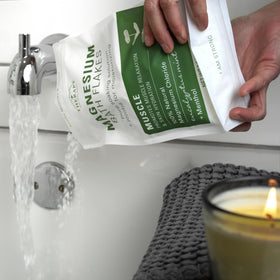 Village Naturals Therapy flakes dissolving in tub water for quick absorption