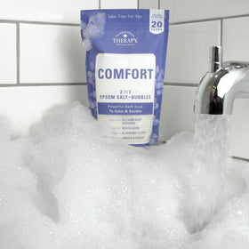 Village Naturals Therapy in a bathroom setting conveying calming home spa