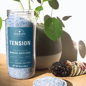 Village Naturals Therapy lifestyle bathroom scene showing pack of three jars for spa-like home care benefit
