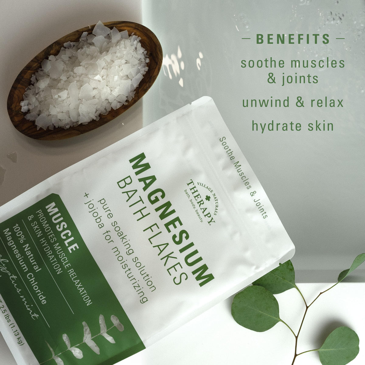 Spoon measuring Village Naturals Therapy flakes for accurate bath portions