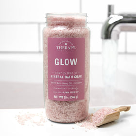 Village Naturals Therapy pouring soak into running tub for an aromatic home spa benefit