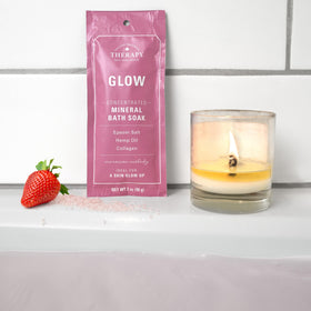 Village Naturals Therapy packet dissolving in bath water showing fragrant diffusion