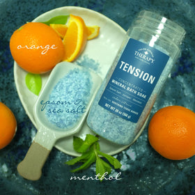 Village Naturals Therapy pouring salt into a bathtub demonstrating simple use for immediate relaxation