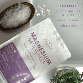 Pouring Village Naturals Therapy flakes into hand to show easy measuring and convenient use