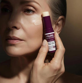 VitailQ balm being applied under the eye for targeted smoothing and moisture
