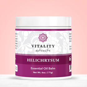 Vitality balm on bathroom shelf styled with towel, suggests everyday skincare ritual
