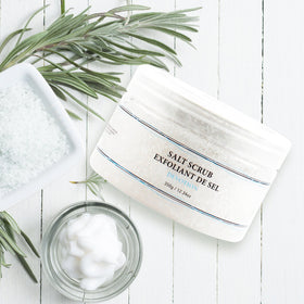Vivo Per Lei applying scrub to leg in shower for smoother skin