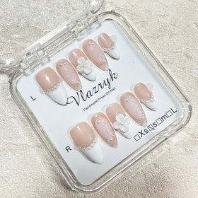 vlazryk finished manicure angled shot showing polish, pearl and floral accents