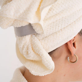 VOLO model wearing wrapped towel showing secure fit and hands-free drying benefit