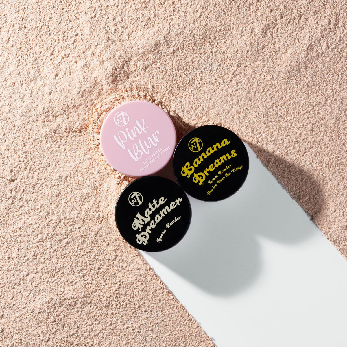 W7 powder application with brush on cheek demonstrating lightweight setting benefit